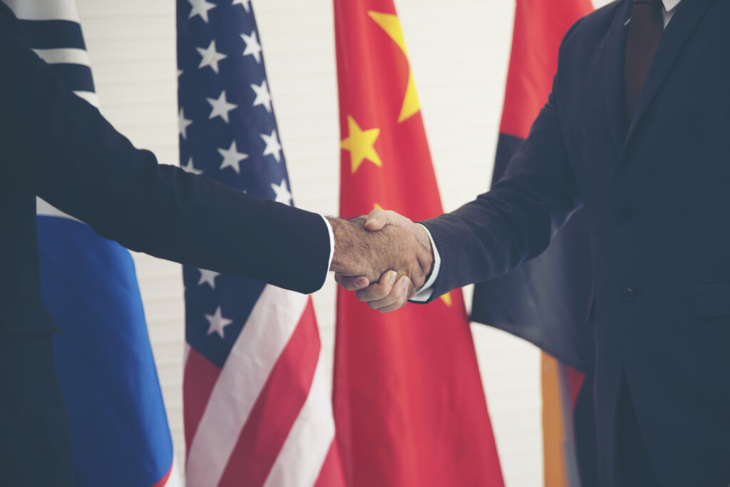 Businessmen shaking hands With an international flag background