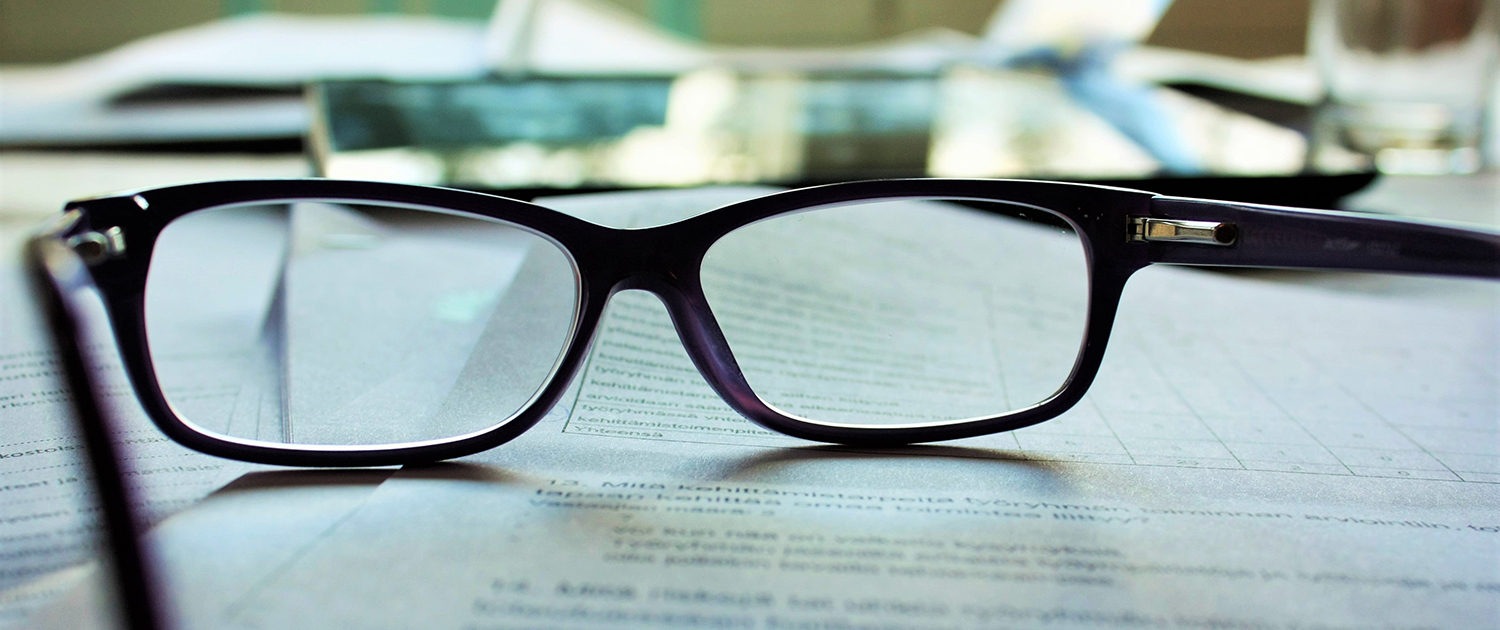 glasses on top of business documents